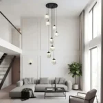 Modern 8-light staircase chandelier fixture installed in a spacious living room with high ceilings.