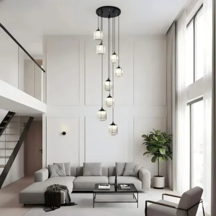 Modern 8-light staircase chandelier fixture installed in a spacious living room with high ceilings.