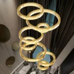 Looking up at an 8-Tier Gold Crystal Chandelier showing the staggered ring design and warm light.