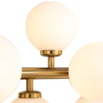 Close-up detail of the brushed brass finish and high-quality milk white glass globe lampshade construction.