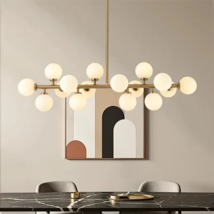 Minimalist 16-globe linear gold pendant light in a contemporary dining room with abstract wall art.