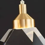 Detail of the brushed gold finish on a spiral raindrop chandelier