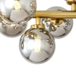 Detailed close-up of a smoky grey glass globe showing beautiful light refraction and internal G9 bulb base.
