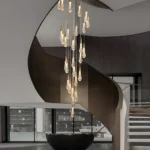 Grand 2-story foyer chandelier featuring cascading spiral glass raindrops and gold finish in a modern home