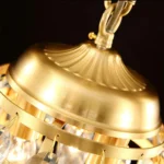 High-detail shot of the antique gold finish and precision metal frame of the pine cone light.
