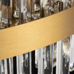 Detailed view of the premium brushed brass gold metal frame finish of the crystal chandelier.