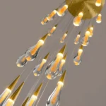 Detailed view of cascading raindrop glass pendants creating a crystal-like lighting effect in modern luxury homes.