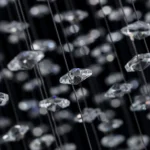 Macro view of precision-cut K9 crystal beads and diamond-shaped pendants for brilliant light refraction.