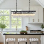 Modern Linear Crystal Chandelier Centered Over a White Kitchen Island