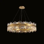 Luxury antique brass crystal chandelier with a round silhouette isolated on a black background.