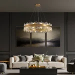 Modern crystal drum chandelier hanging above a cream sofa in a luxury contemporary living room.