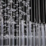 Detail shot of high-quality glass rods and hanging crystals for the modern foyer chandelier