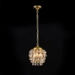 Professional studio display of a modern pine cone pendant light with gold chain on a solid black background.