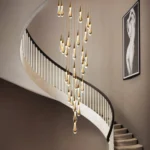 Modern 16-light linear dining chandelier with glass globes installed over a large wooden table