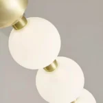 Detailed View of Pearl Acrylic Beads on a Modern Gold Chandelier Ring