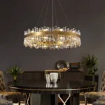 Antique gold crystal chandelier perfectly scaled for a round black dining table.