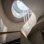 Extra long beaded chandelier with k9 crystals installed in a spiral staircase landing