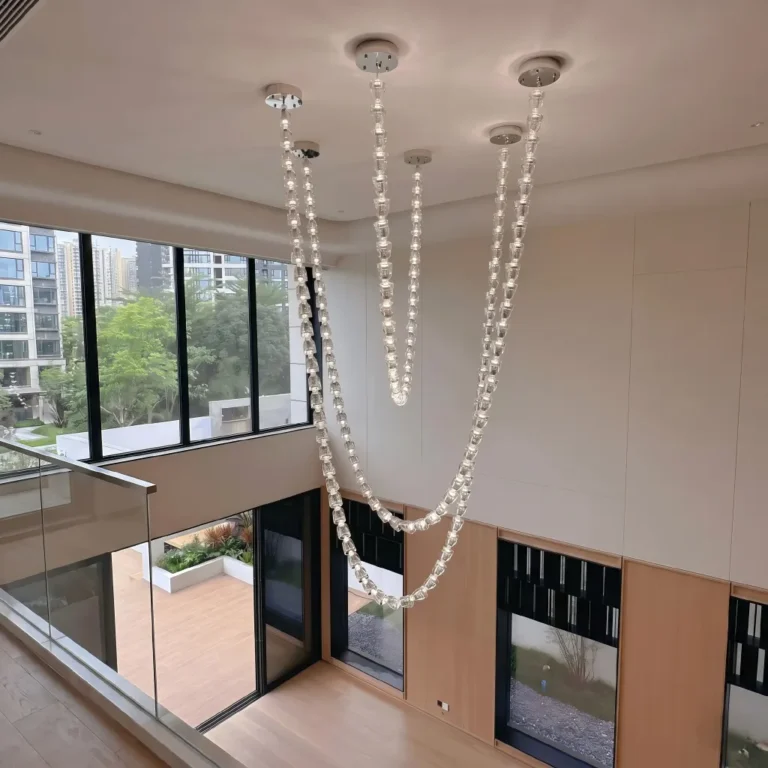 Lux beaded chandelier with modern crystal necklace design for high ceiling stairwell