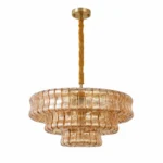 Amber tiered glass chandelier with gold finish on white background