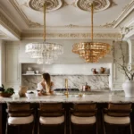 Clear and amber glass chandeliers over a luxury kitchen island
