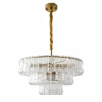 Clear tiered glass chandelier with gold finish on white background