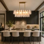 Modern linear chandelier with hand-blown glass above a large kitchen island