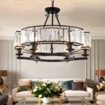 Black farmhouse chandelier with clear crystal prisms displayed in a bright living room