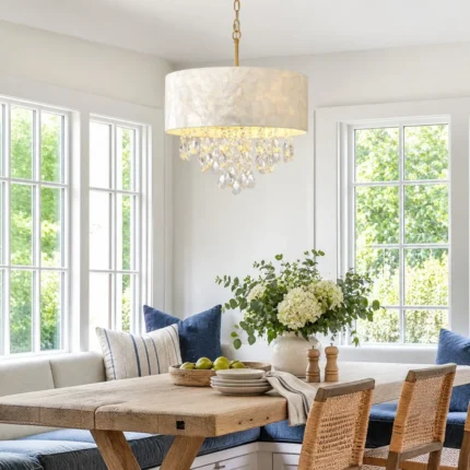 Drum shade chandelier with white shell shade and crystal drops in a bright breakfast nook