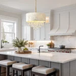 Drum shade chandelier with shell shade and crystal drops above a kitchen island
