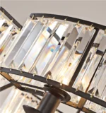 Close-up of clear K9 crystal prisms and black metal frame on a farmhouse crystal chandelier