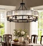 Farmhouse dining chandelier with clear crystal prisms illuminating a traditional wood dining table
