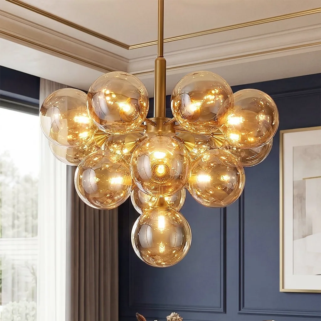 Close-up of glass bubble chandelier with amber globe shades and gold frame