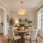Glass disc chandelier with gold-tone frame above a round dining table