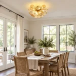 Glass disc chandelier above a dining table in a bright modern dining room