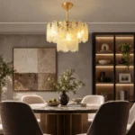 Gold glass chandelier above a modern round dining table