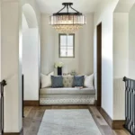 Hallway chandelier with black frame and crystal drops in a bright interior