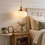 Milk glass pendant light with white glass shade hanging in a modern bedroom