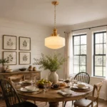 Milk glass pendant light with gold details in a modern dining space