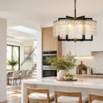 Black and gold farmhouse chandelier with textured glass above a kitchen island
