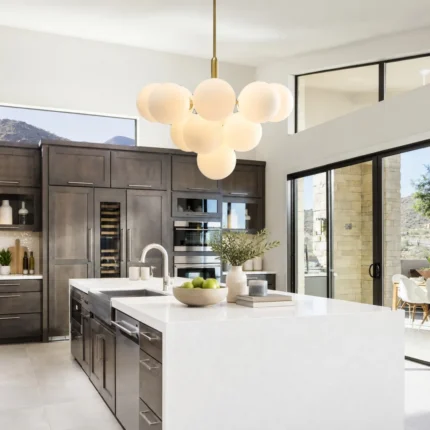 Modern globe chandelier with milk glass shades over a kitchen island