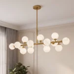 Modern linear chandelier featuring brushed gold metal and hand-painted marble-look glass globes