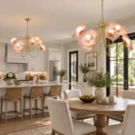 Red floral chandelier above a kitchen and dining area