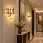 Pair of crystal sconces with smoke gray and clear crystals illuminating a modern hallway.