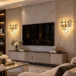 Crystal sconces with tiered smoke gray and clear crystals flanking a living room TV wall.