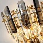 Close-up of smoke gray and clear faceted crystal bars with gold-tone metal fittings.