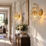 Pair of Style B crystal wall sconces with round crystal drops and gold frames in a residential hallway