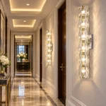 Crystal wall sconces with faceted glass details illuminating a luxury hallway with marble flooring
