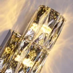 Close-up of faceted crystal panels and reflective metal details on a crystal wall sconce