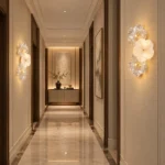 Pair of three-flower decorative wall sconces lighting opposite walls of a modern hallway