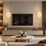 Pair of three-flower wall sconces framing a living room television and floating console